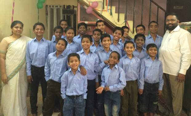 Pic from Caters News - (Pictured: Papa Reji, Rajib Thomas with with his wife Mini Reji and the kids he adopted.) - An Indian man has become a father to two dozen children after adopting 22 HIV positive boys, who were abandoned by their parents after being struck by the diseased. Called lovingly as Papa Reji, Rajib Thomas, 44, from Mumbai, India has been taking care of the once homeless HIV positve children for almost a decade now. He accommodates all his children in his home where he lives with his wife and two kids- Justin 18 and Jenny, 16. While his wife Mini Reji cooks all the three meals for their kids, Papa Reji takes care of their education and heath. Papa Reji was working in the social sector when an incident changed his life forever and made him a father of these special children. SEE CATERS COPY
