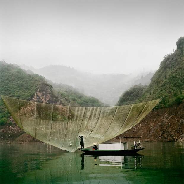 Father and son fishermen pull in a catch using a large net early in the morning on the Yangtze River in Wushan, China. The Yangtze is the third-longest river in the world, stretching more than 3,900 miles across China.