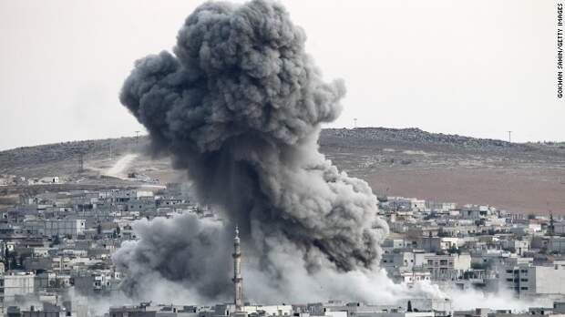 Heavy smoke rises following an airstrike by the U.S.-led coalition aircraft in Kobani, Syria, during fighting between Syrian Kurds and ISIS fighters, as seen from the outskirts of Suruc, on the Turkey-Syria border, on Saturday, October 18. Civil war has destabilized Syria and created an opening for the militant group, which also is advancing in Iraq as it seeks to create an Islamic caliphate in the region.