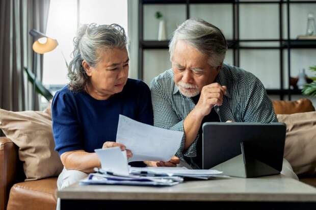 Serious couple discussing a document together.